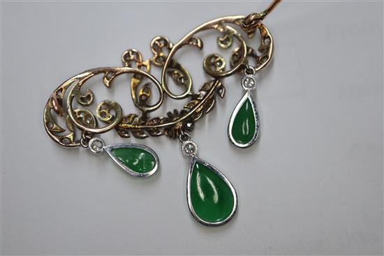 A 1920s yellow metal, diamond and jadeite set drop openwork scroll brooch, width 38mm.